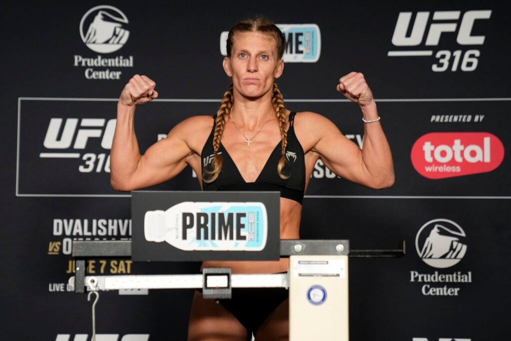 Kayla Harrison poses with fists up after making weight for UFC 316