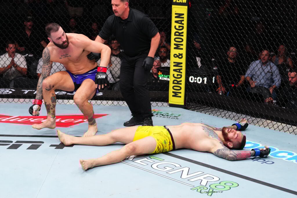 Image of Paul Craig and Rodolfo Bellato laying down on the canvas at UFC Atlanta