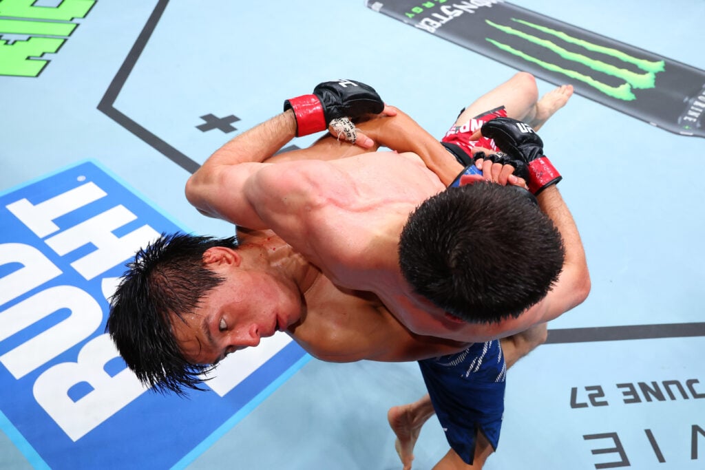 Image of Azat Maksum attempting a takedown on Tagir Ulanbekov
