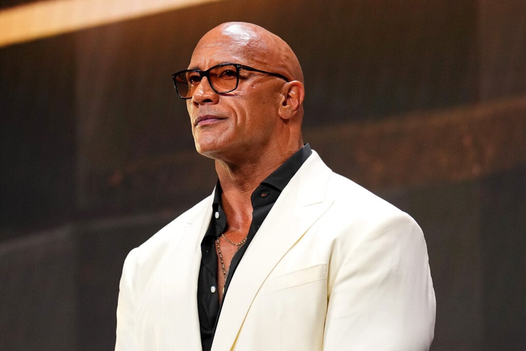 Dwayne 'The Rock' Johnson wearing a white suit at the UFC Hall of Fame