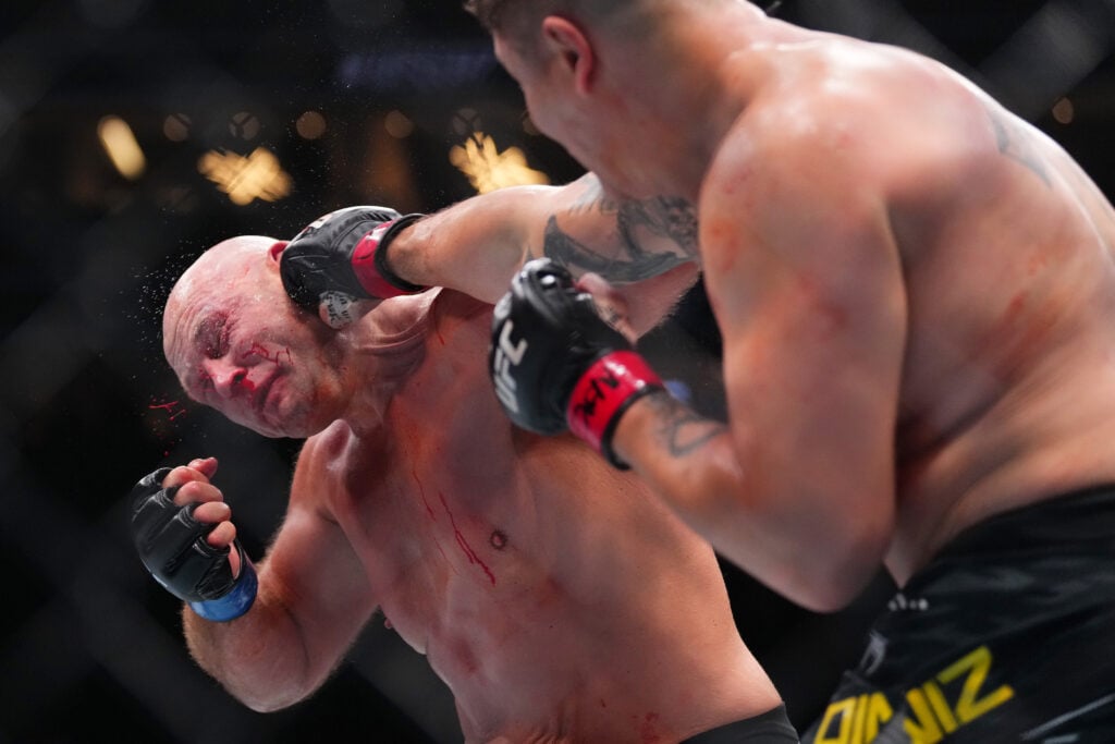 Jhonata Diniz punches Alvin Hines during their fight at UFC 317.