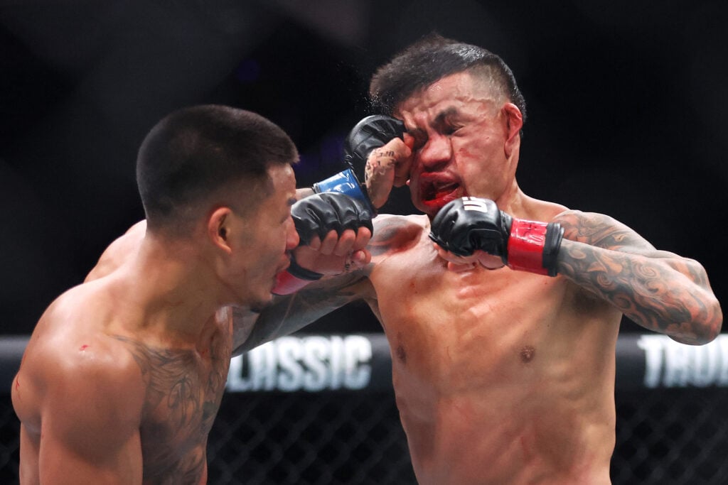 Joshua Van punches Brandon Royval during their flyweight bout at UFC 317