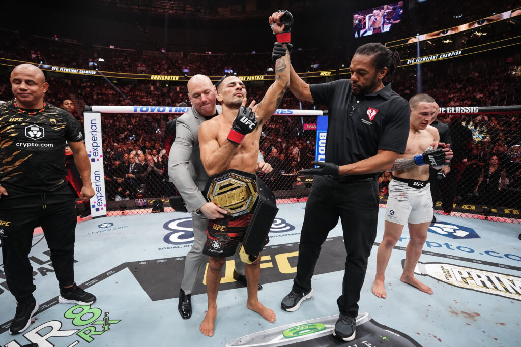 Alexandre Pantoja gets the flyweight title wrapped around his waist after his win over Kai Kara-France at UFC 317.