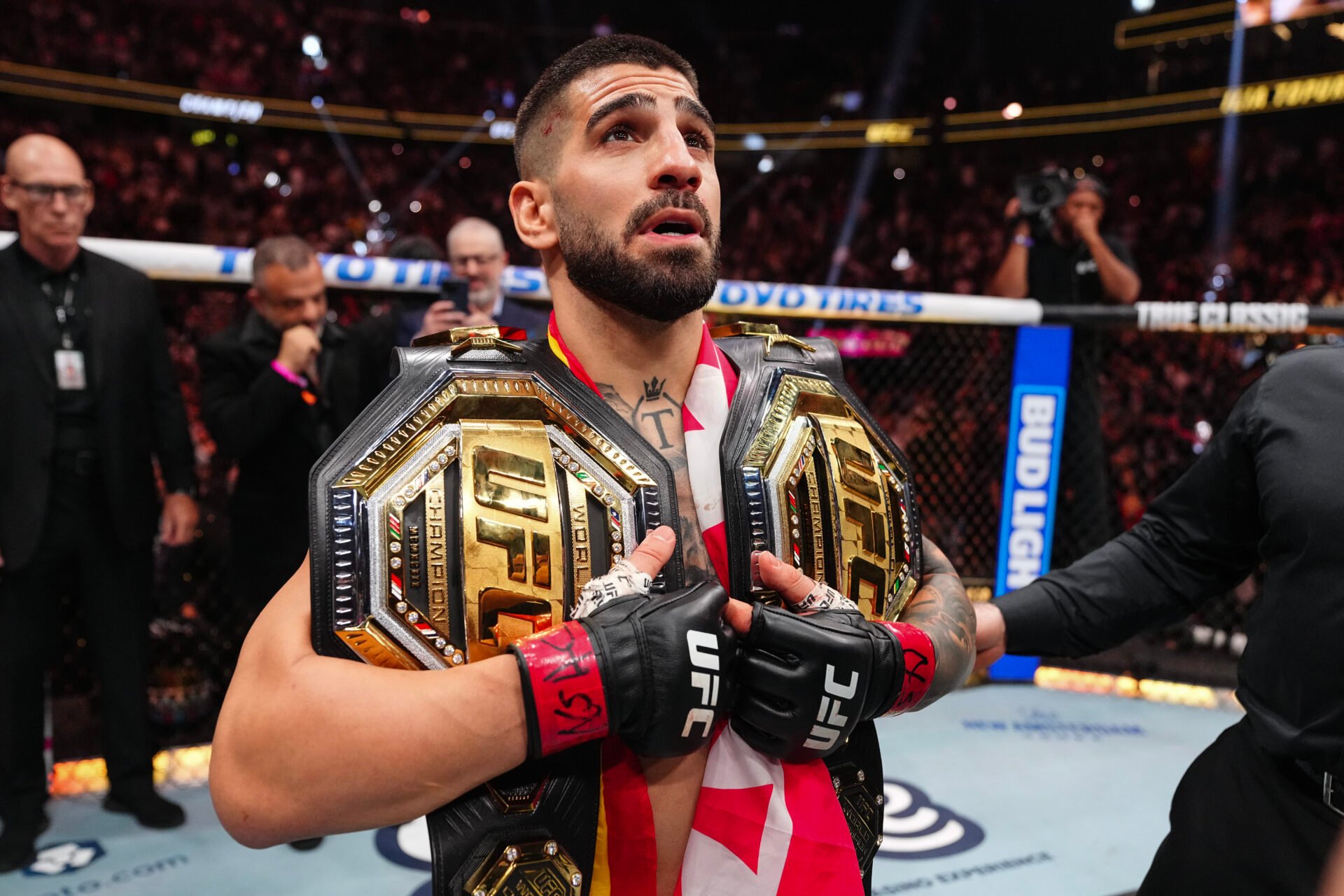 Ilia Topuria celebrates defeating Charles Oliveira at UFC 317