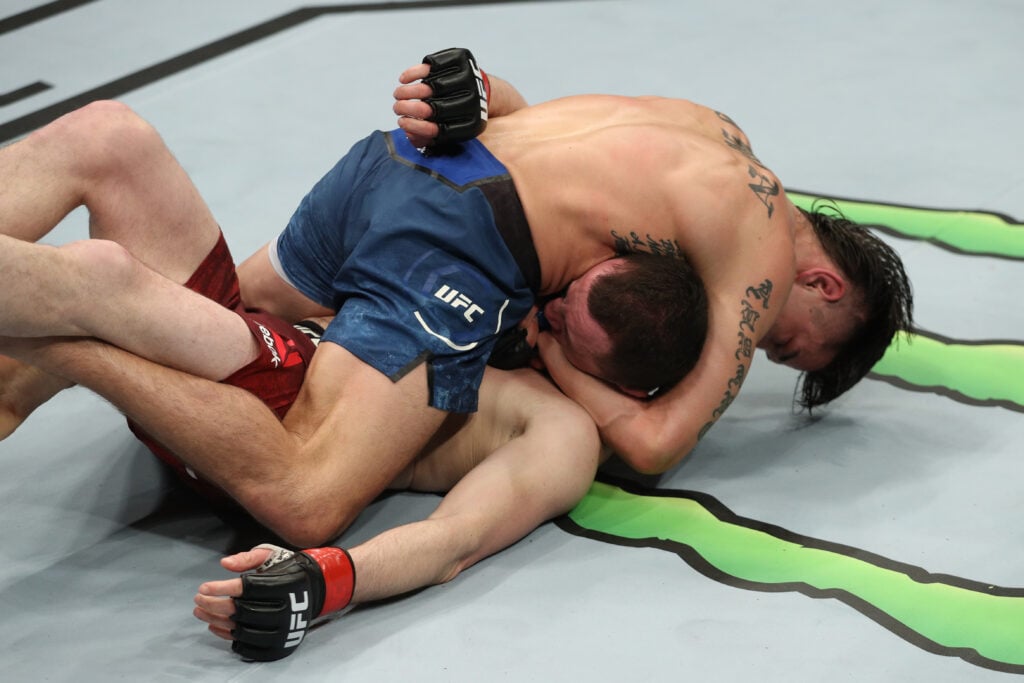 Ricky Simon chokes Merab Dvalishvili during their UFC bantamweight fight