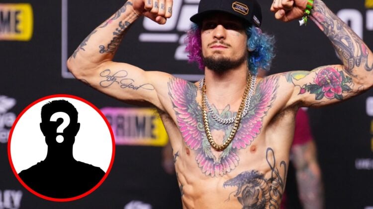 Sean O'Malley poses on the scales during the UFC 299 ceremonial weigh-ins with an inset of a mystery icon