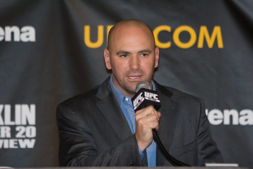 Dane White speaks into a microphone at the UFC 77 Press conference
