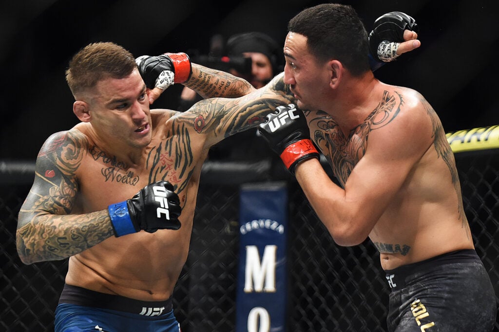 Dustin Poirier and Max Holloway throw punches at one another during their second fight at UFC 236.