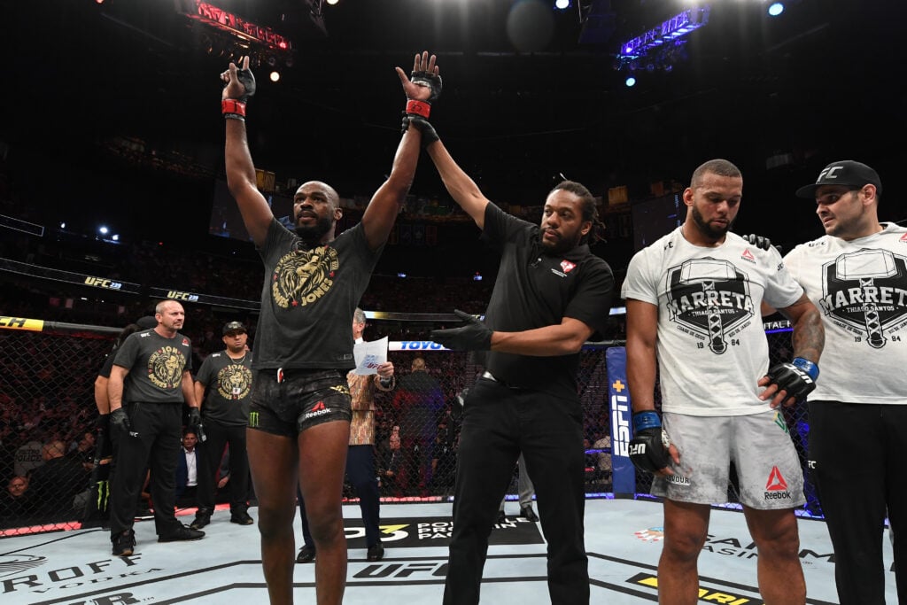 Jon Jones gets his hand raised after beating Thiago Santos at UFC 239