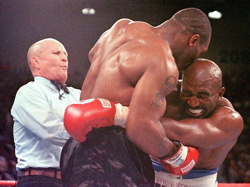 Mike Tyson bites Evander Holyfield's ear during their boxing title fight in 1997.