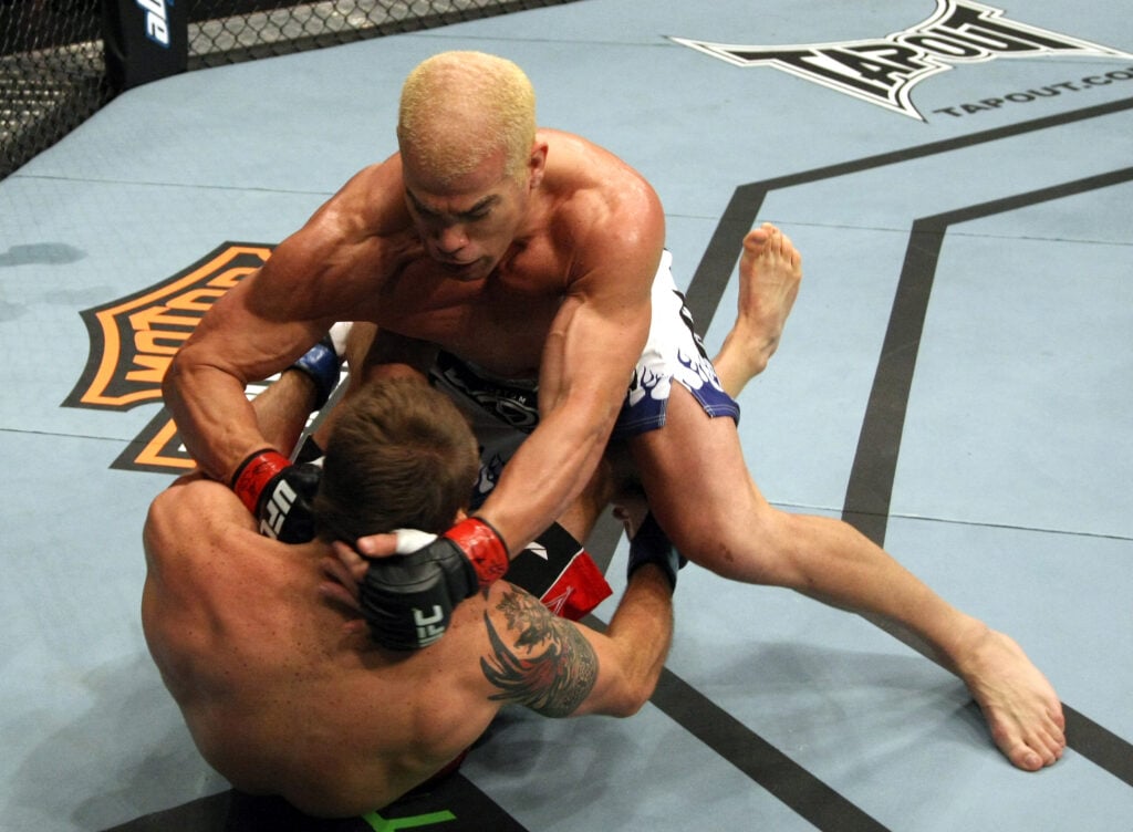 Tito Ortiz gets on top of Ryan Bader and begins to punch him on the mat at UFC 132.