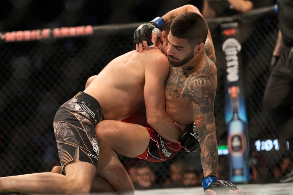Bryce Mitchell grapples with Ilia Topuria during their fight at UFC 282.