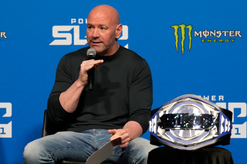 Dana White on stage next to the Power Slap title belt