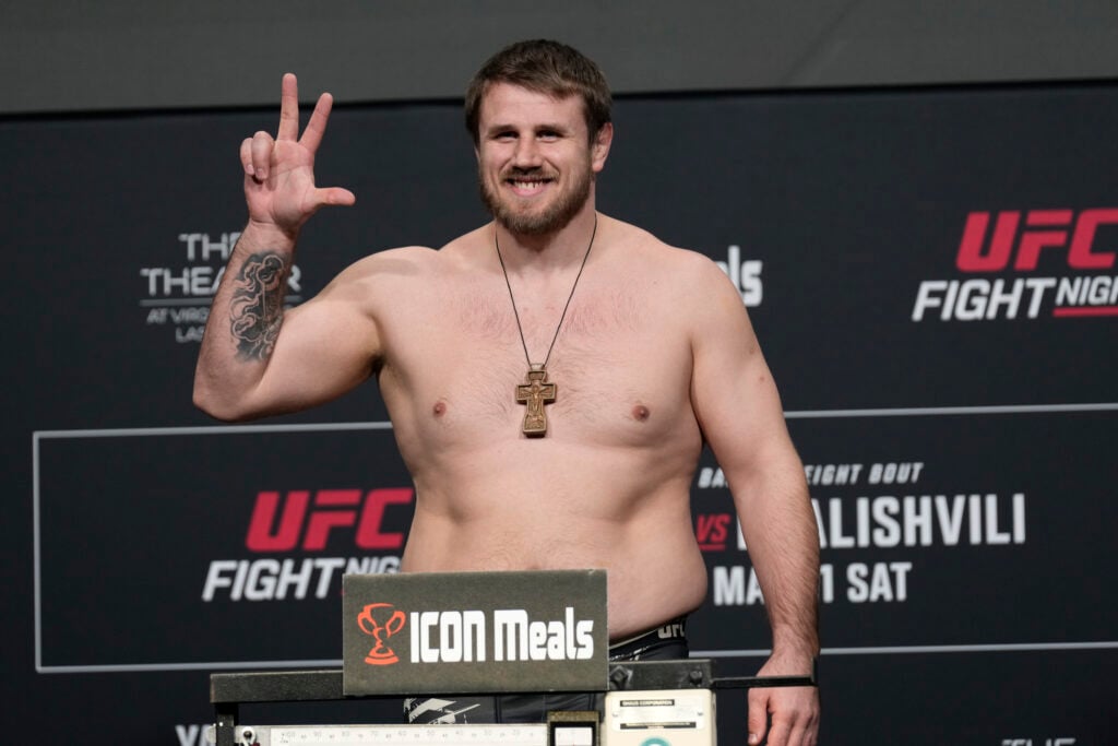 Alexander Romanov poses on the scale for his fight at UFC Fight Night: Yan vs. Dvalishvili