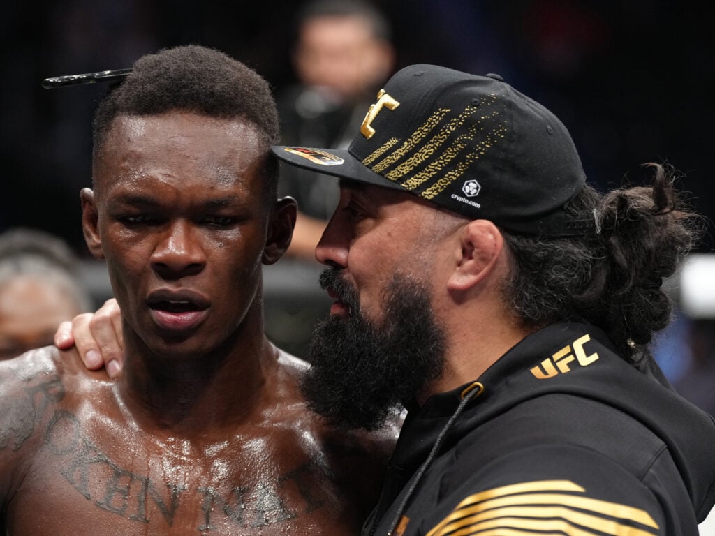 Coach Eugene Bareman talks to Israel Adesanya after his victory over Jared Cannonier at UFC 276.