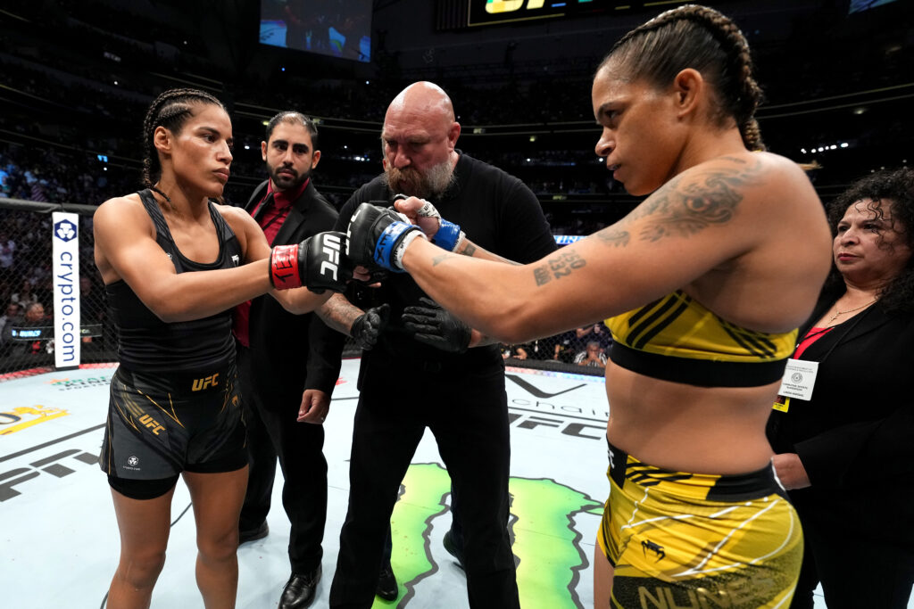 Julianna Pena and Amanda Nunes touch gloves ahead of their title fight at UFC 277.