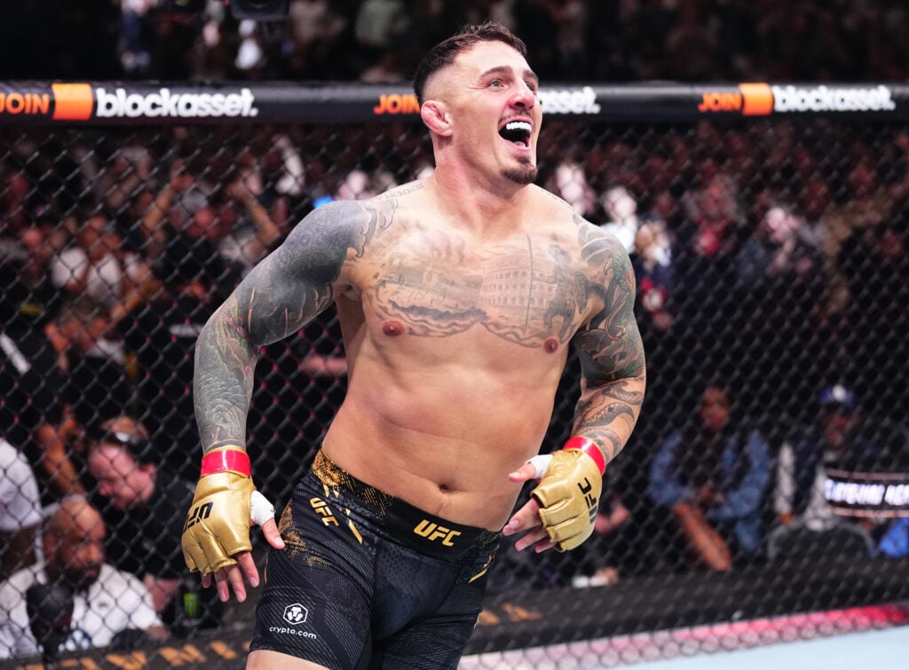 Tom Aspinall celebrates after knocking out Curtis Blaydes in their title fight at UFC 304.