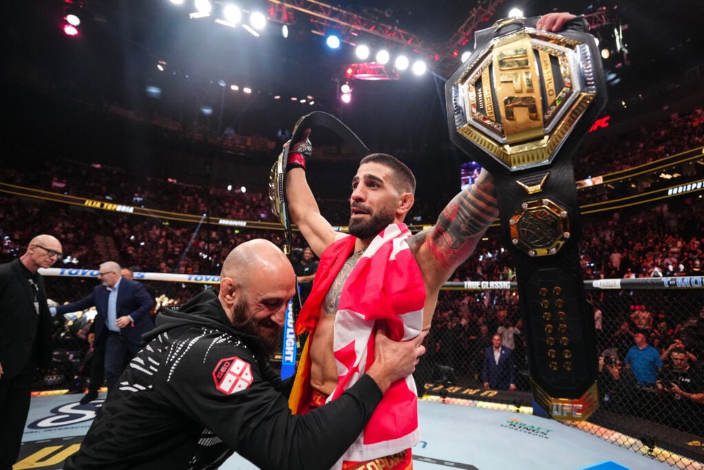 Ilia Topuria interacts with one of his coaches after his knockout win at UFC 317