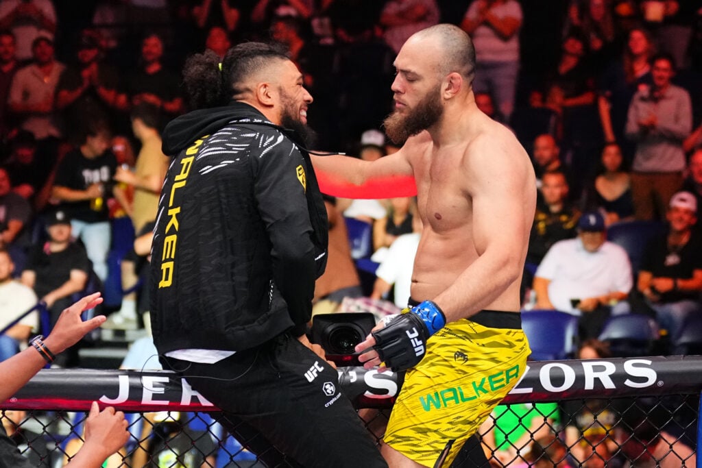 Valter Walker and brother Johnny Walker embrace on the cage at UFC Nashville