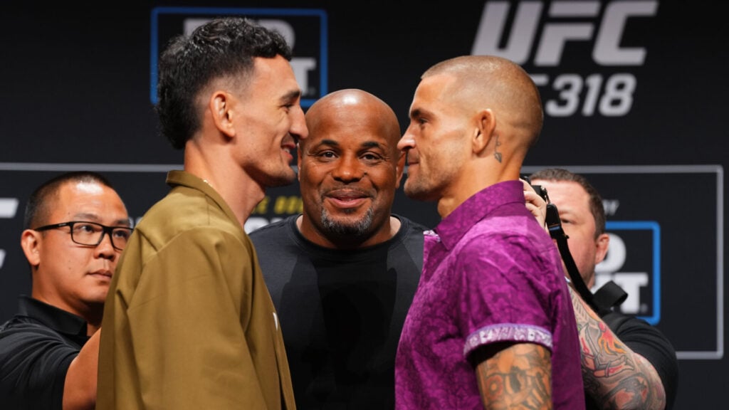 Daniel Cormier oversees Dustin Poirier's face-off with Max Holloway at the UFC 319 press conference