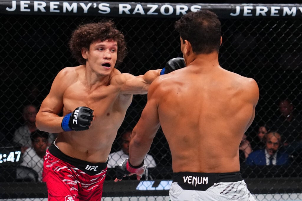 Roman Kopylov punches Paulo Costa during their fight at UFC 318
