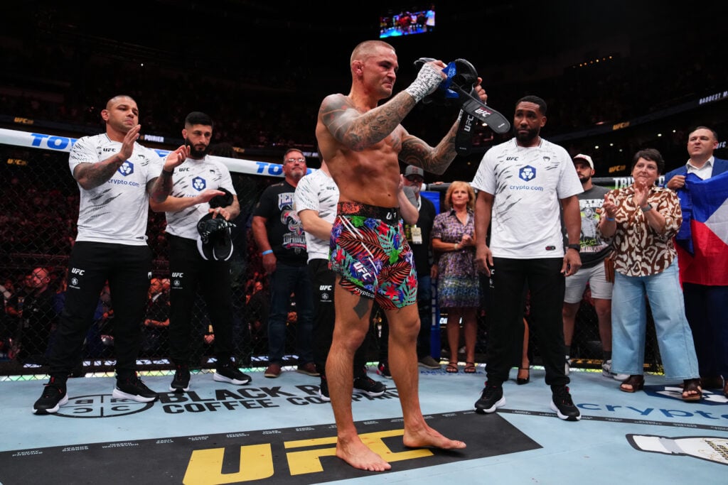 Dustin Poirier takes his gloves off to retire after his UFC 318 defeat to Max Holloway.