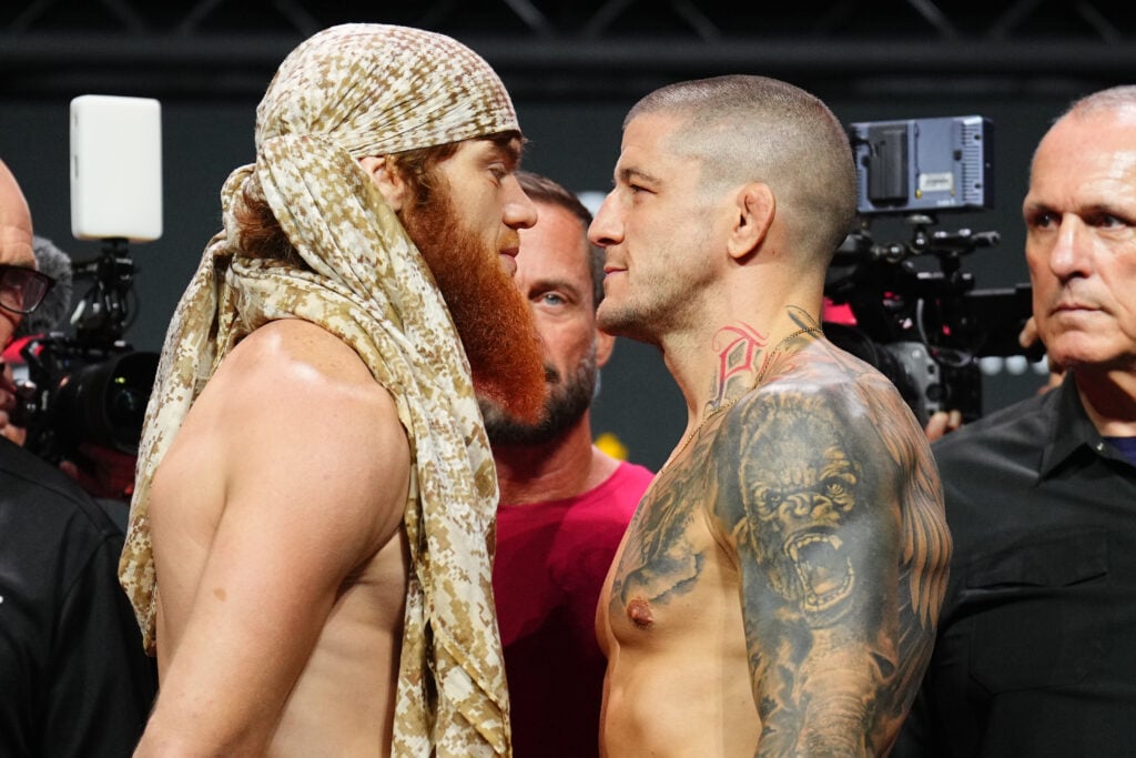 Shara Magomedov, wearing a head covering, faces off with Marc-Andre Barriault at the UFC Abu Dhabi weigh-ins
