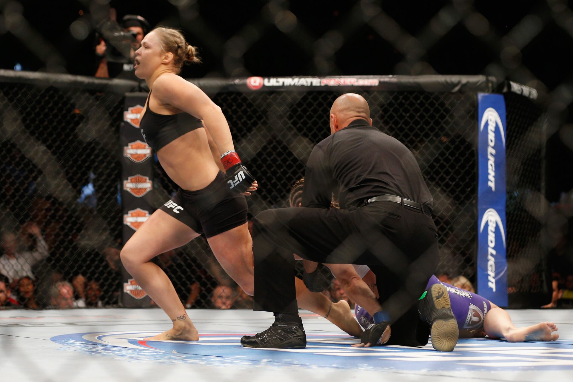 Ronda Rousey celebrates after finishing Alexis Davis at UFC 175
