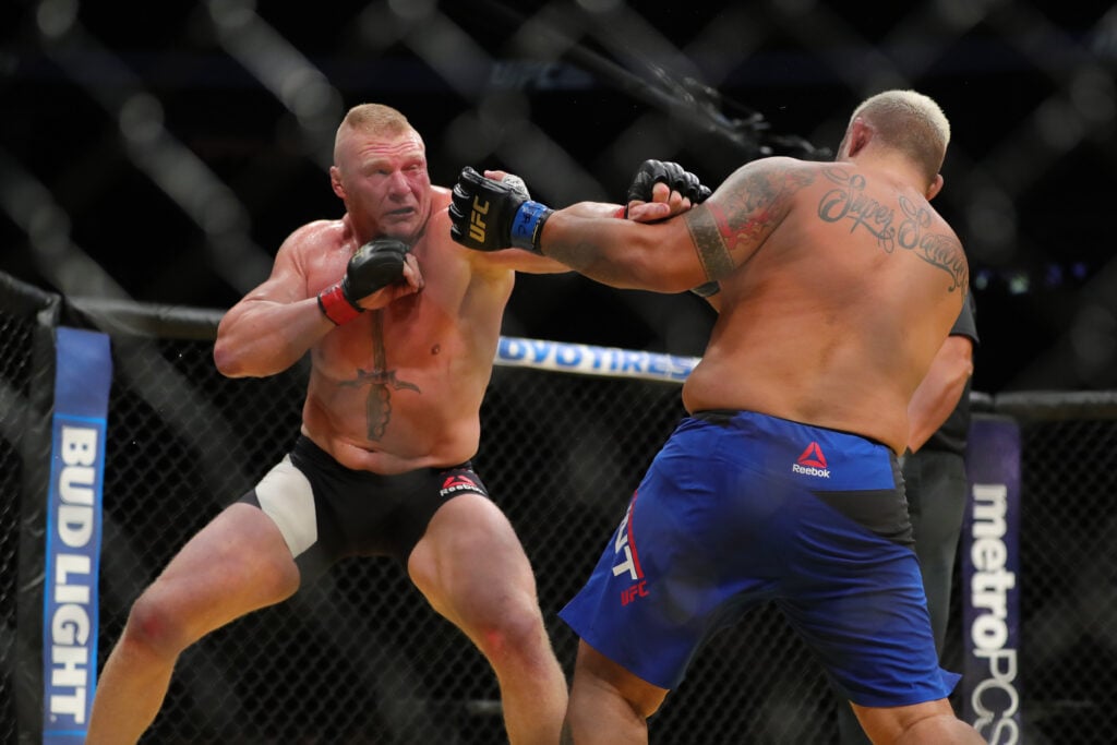 Brock Lesnar punches Mark Hunt during their fight at UFC 200
