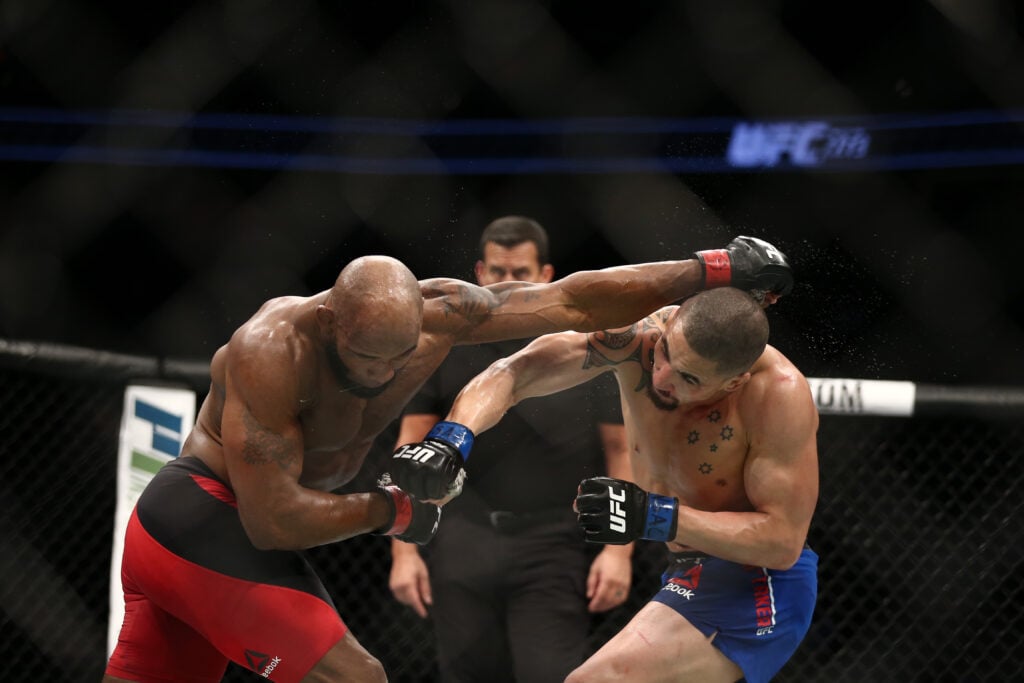 Robert Whittaker and Yoel Romero trade punches during UFC 213 main event