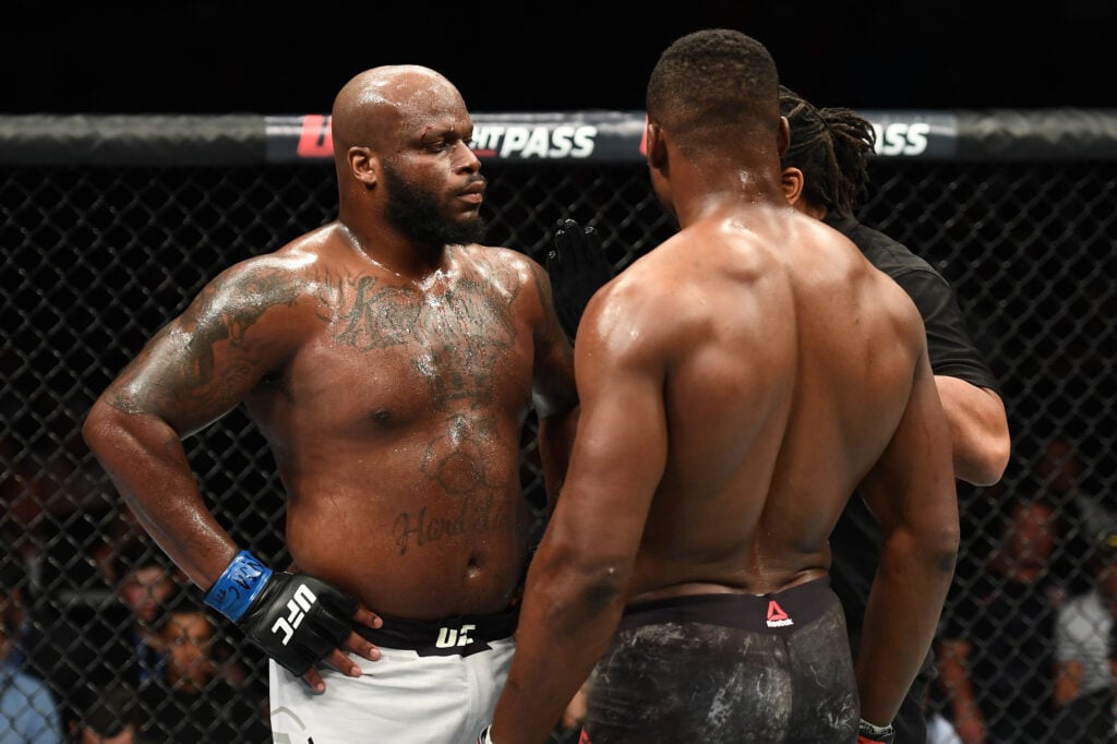 Herb Dean speaks to Derrick Lewis and Francis Ngannou during their fight at UFC 226
