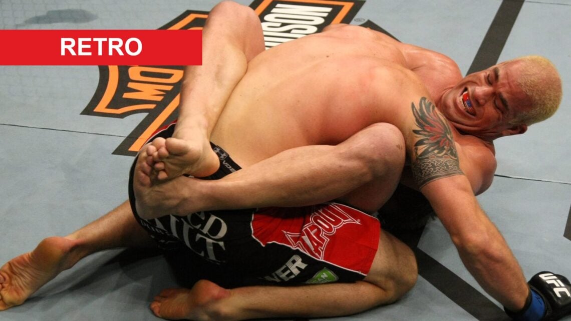 Tito Ortiz grimaces as he locks in the guillotine choke on Ryan Bader in the octagon at UFC 13, with a red rectangle labeled "retro" in the top lef...