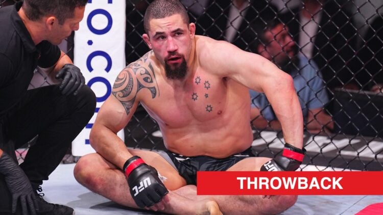 Robert Whittaker sits crossed legged in the octagon after a submission loss to Khamzat Chimaev
