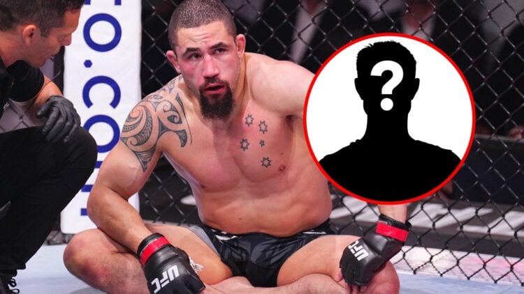 Robert Whittaker sits crossed legged in the octagon after a submission loss to Khamzat Chimaev