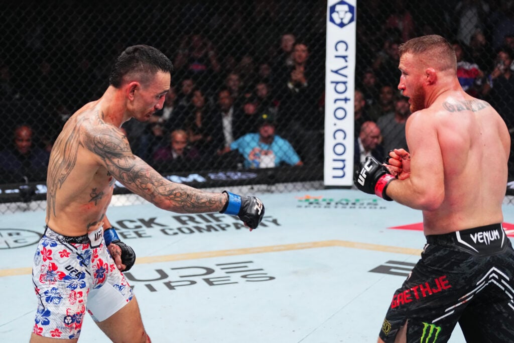 Max Holloway points down to the UFC canvas against Justin Gaethje at UFC 300