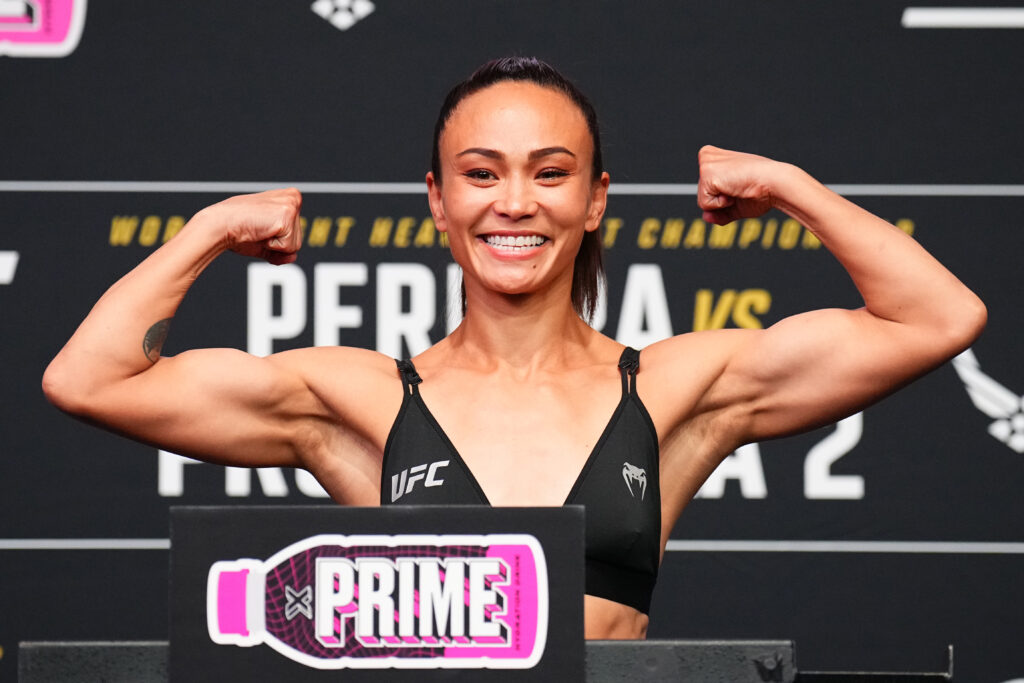 Michelle Waterson-Gomez poses on the scale during the UFC 303 ceremonial weigh-in