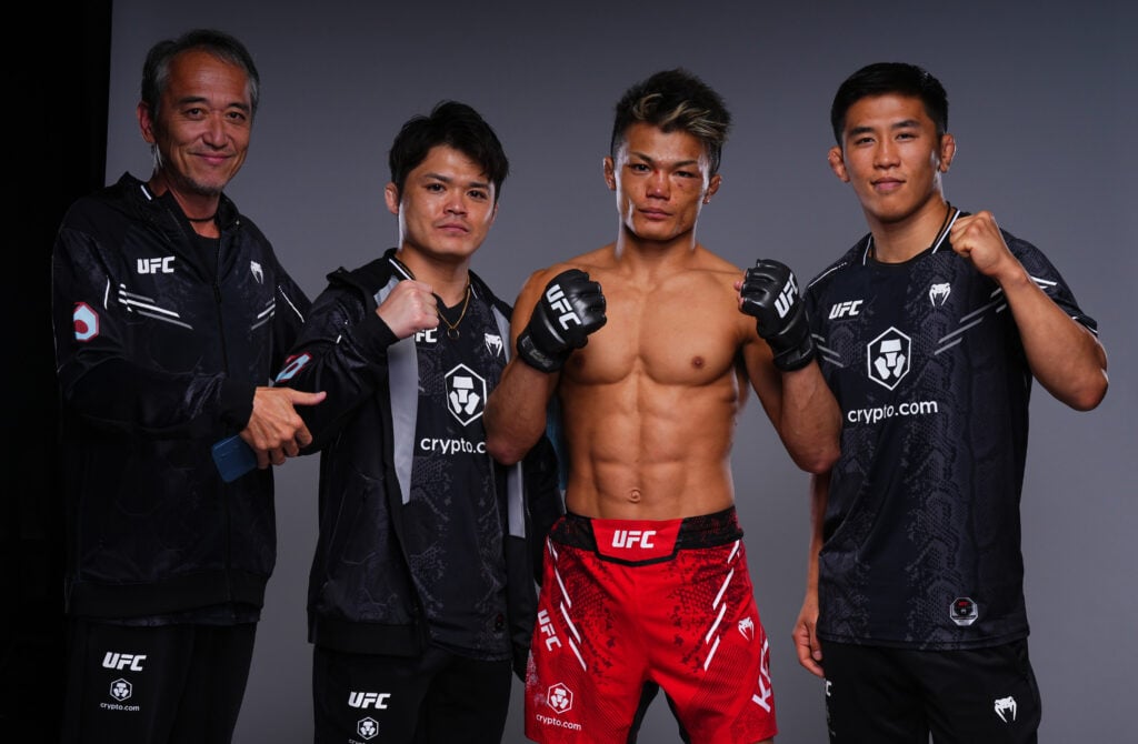 Toshiomi Kazama poses with his team for a UFC portrait