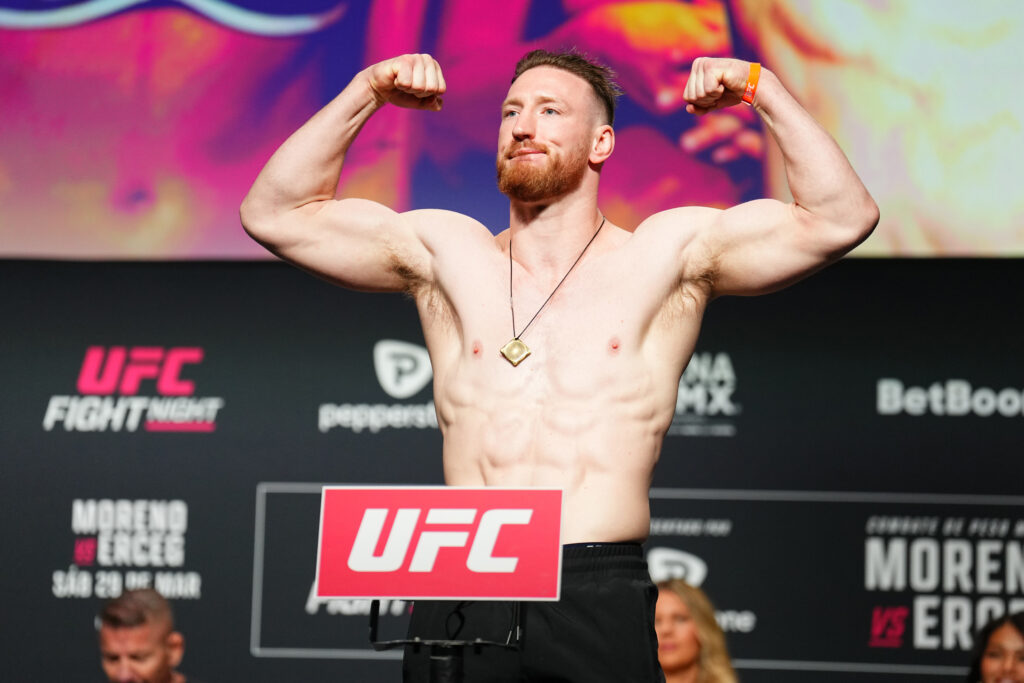 Joe Pyfer flexes on the scale during the UFC Mexico City ceremonial weigh-in