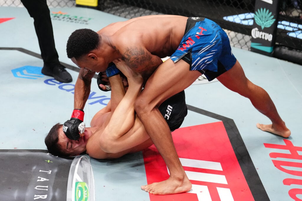 Elijah Smith punches Toshiomi Kazama during their bantamweight bout at UFC Vegas 109