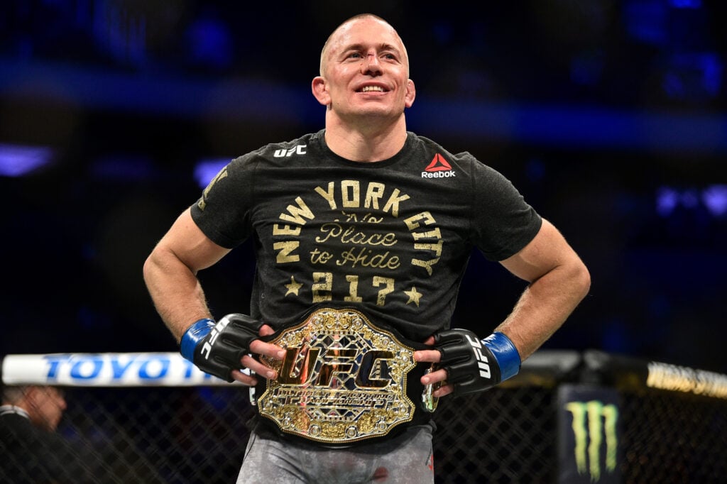 Georges St-Pierre poses with the UFC middleweight title after defeating Michael Bisping at UFC 217