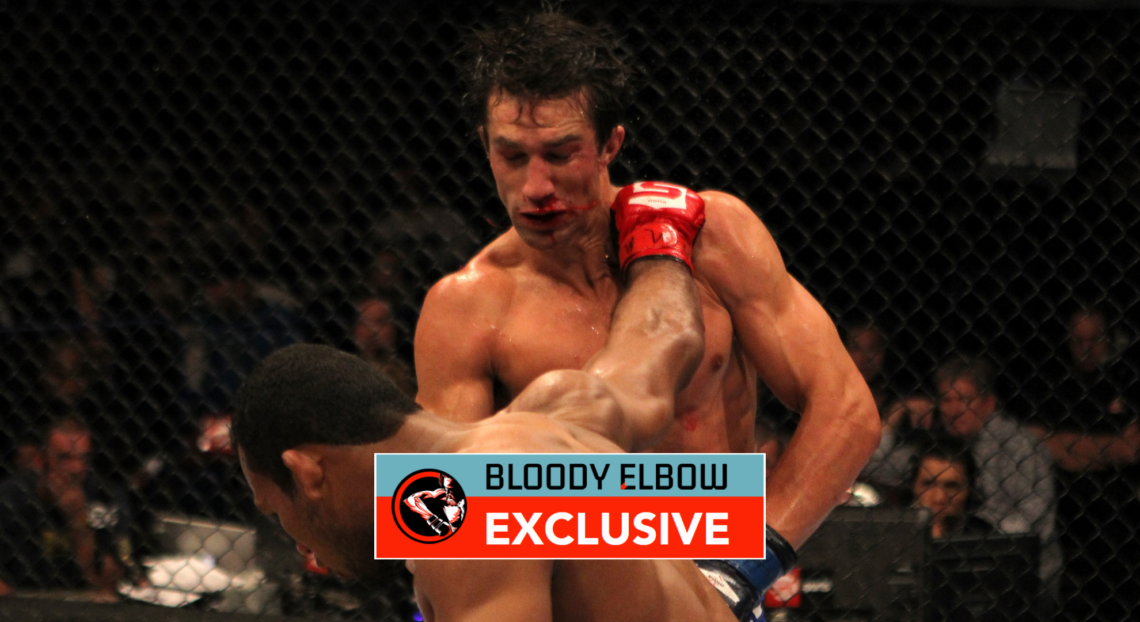 Luke Rockhold takes a punch from Ronaldo 'Jacare' Souza during a Strikeforce fight. Overlay text reads BLOODY ELBOW EXCLUSIVE