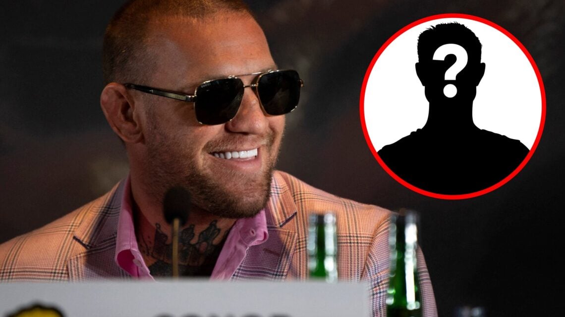 Conor McGregor smiles on stage at a BKFC press conference in Marbella, inset mystery icon