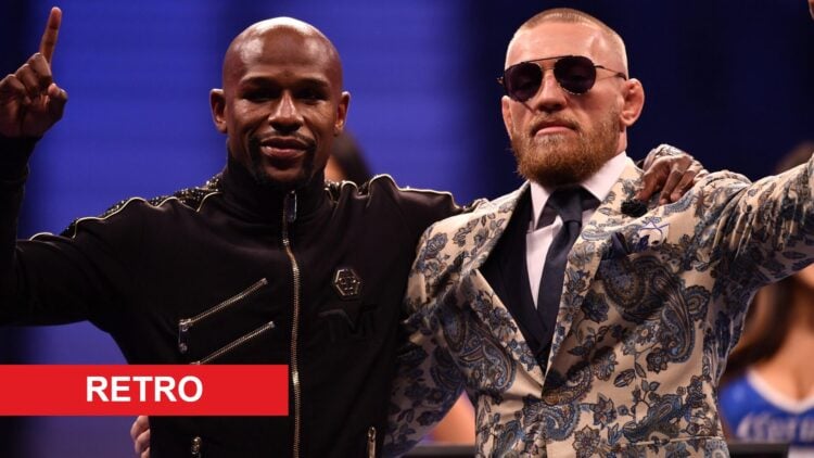 Conor McGregor poses with Floyd Mayweather at the post-fight press conference after their boxing match in 2017.