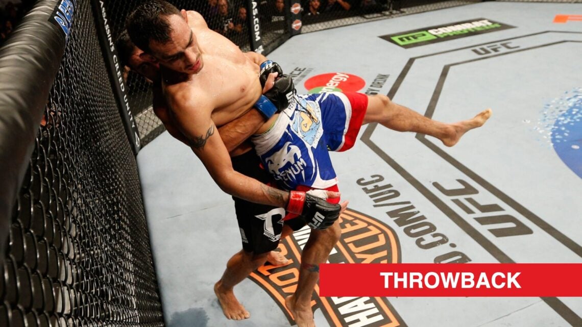 Danny Castillo lifts and throws Tony Ferguson during their fight at UFC 177