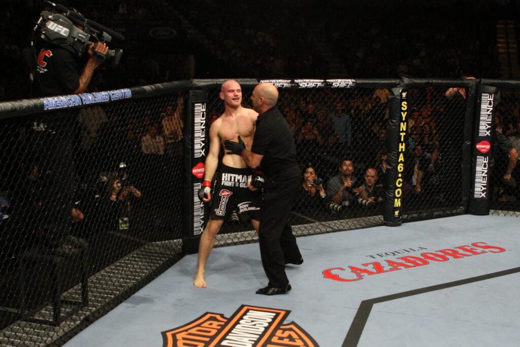 Martin Kampmann is held by the referee after getting finished with strikes against Paul Daley at UFC 103