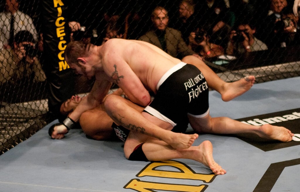 Tim Sylvia punches Ricco Rodriguez on the ground during their title fight at UFC 41
