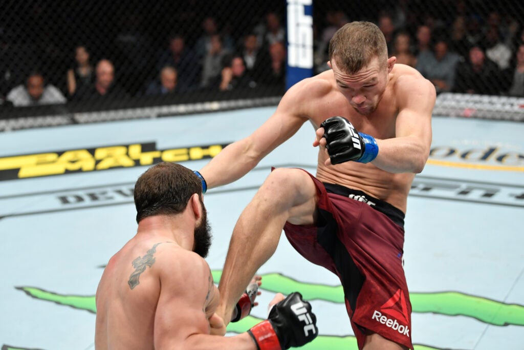 Petr Yan throws a kick at Jimmie Rivera at UFC 238