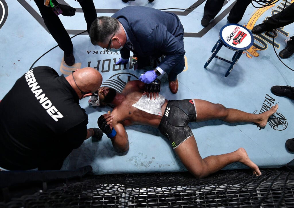 Tyron Woodley is checked by doctors after losing to Colby Covington