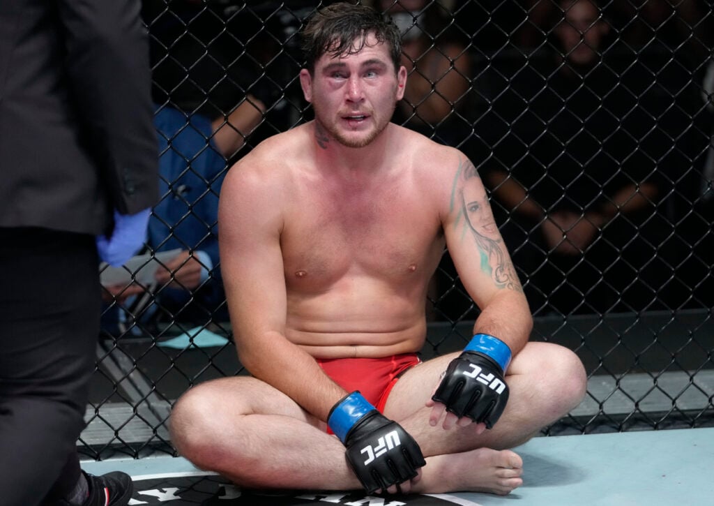 Darren Till sits on the floor after his loss to Derek Brunson