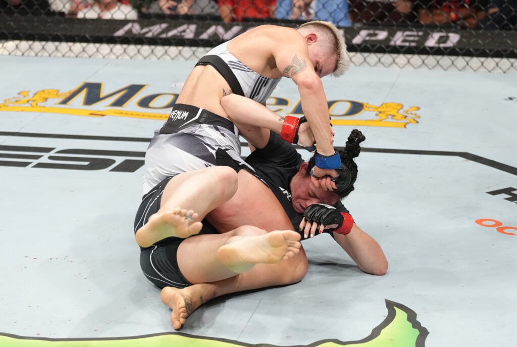 Macy Chiasson punches Irene Aldana from top position during their fight at UFC 279
